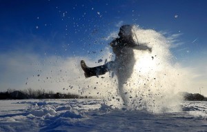 Archie Kirk plays in the snow as his sch